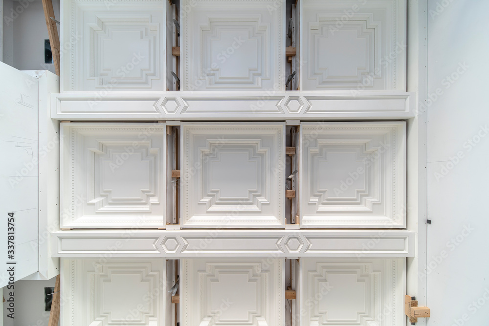 White square coffered ceiling installation with designer beams Stock