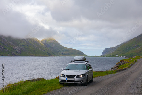 Lofoten, Norway - June 20, 2017: A gray car parked on the shore of a Norwegian fjord © Tatiana