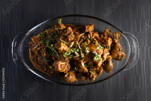 chicken karahi in a dish on a dark background photo