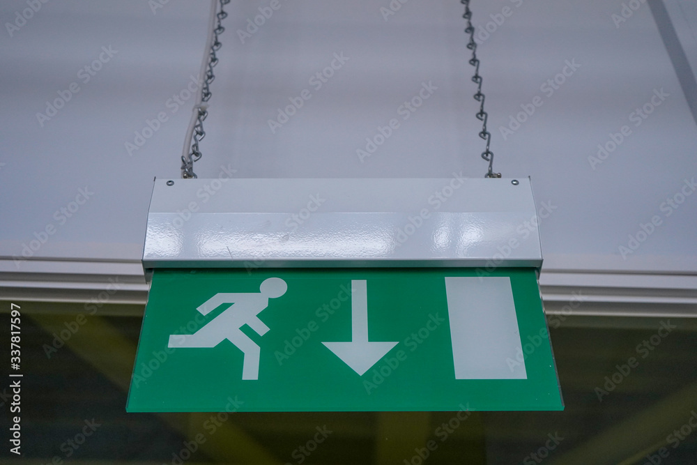 Emergency exit sign hanging on a wall Stock Photo Adobe Stock