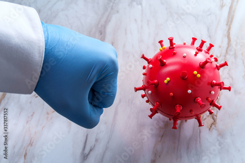 Scientist Punching Coronavirus Model photo