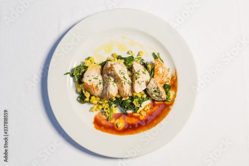 Grilled chicken breasts with cooked vegetables corn and chard