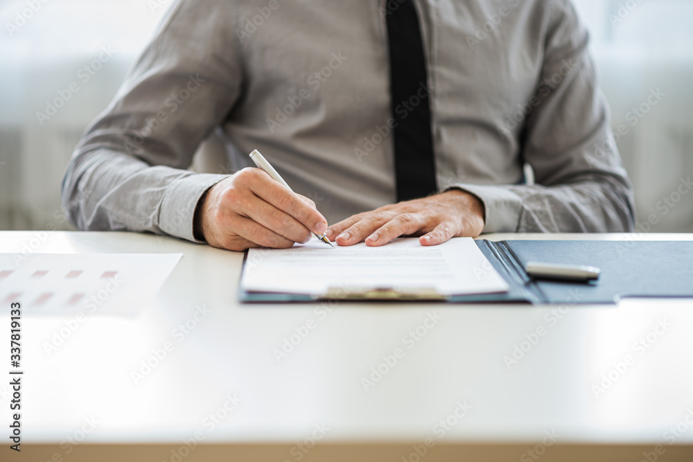 Businessman or lawyer signing a document Businessman or lawyer signing a document