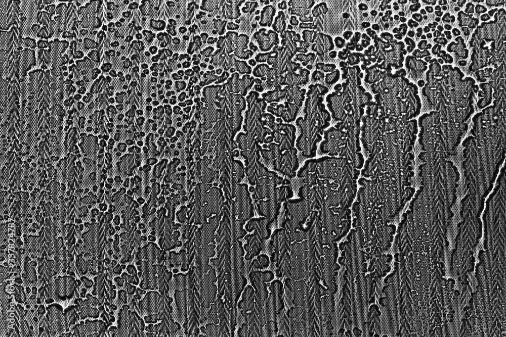 Obraz premium View on a black-white background with the texture of flowing drops of water on glass through a transparent fabric. Concept background, texture.