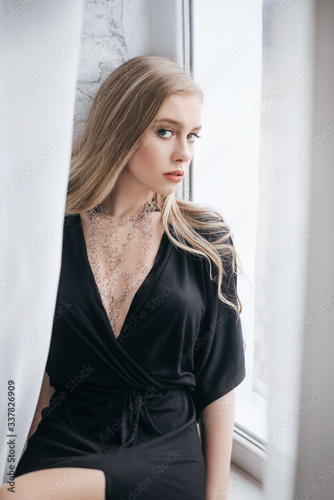 Portrait of beautiful young blonde girl with makeup in black fashion clothes Portrait of beautiful young blonde girl with makeup in black fashion clothes