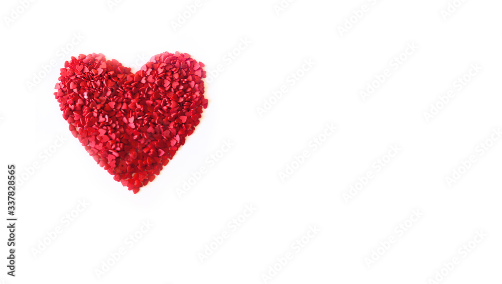 Minimalistic red heart made of confetti on a white background for a card for Valentine's Day. Top view.