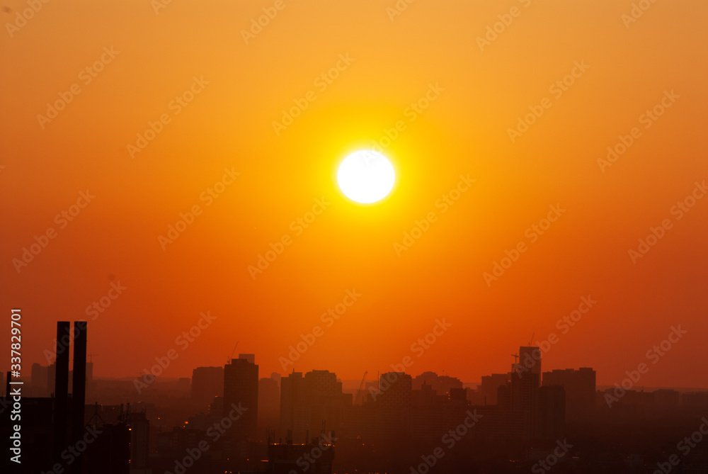 Sunset over urban horizon with orange sky