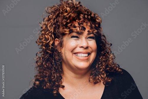 Beautiful Young Woman Smiling on gray Background
