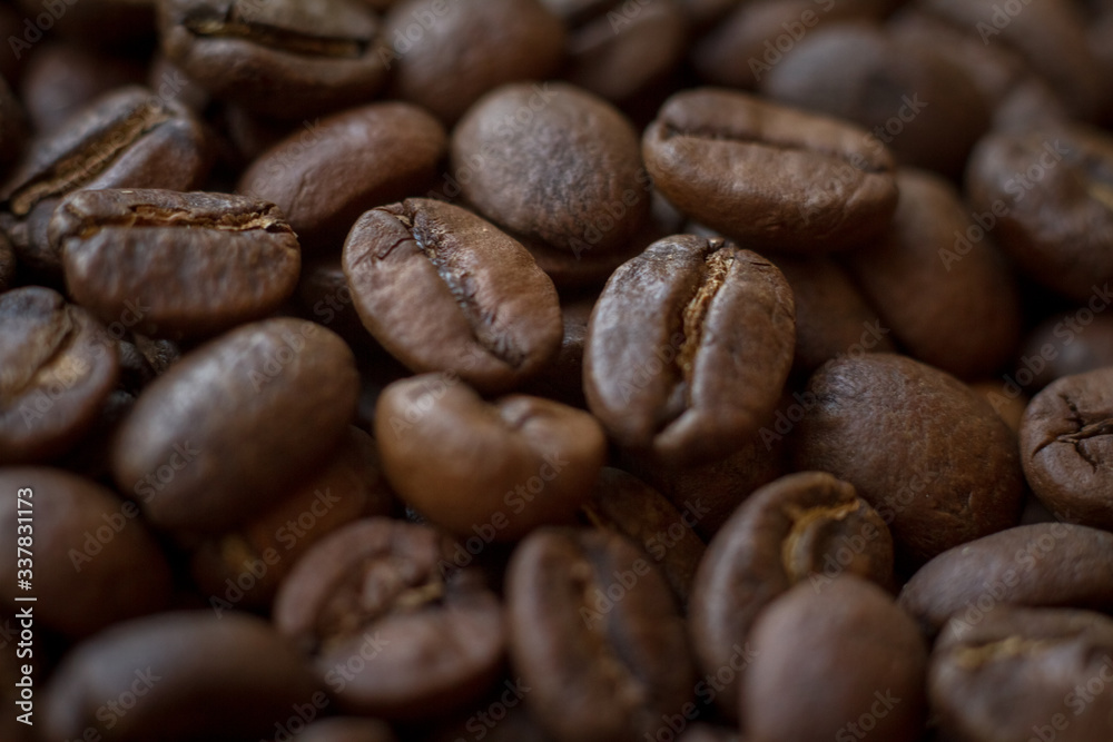 Extremely close-up background roasted coffee beans with gold streaks, good morning concept Extremely close-up background roasted coffee beans with gold streaks, good morning concept