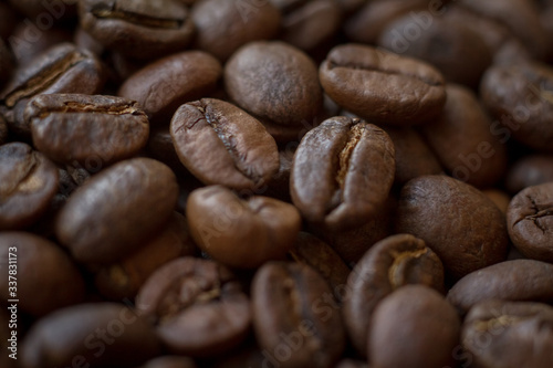 Extremely close-up background roasted coffee beans with gold streaks, good morning concept