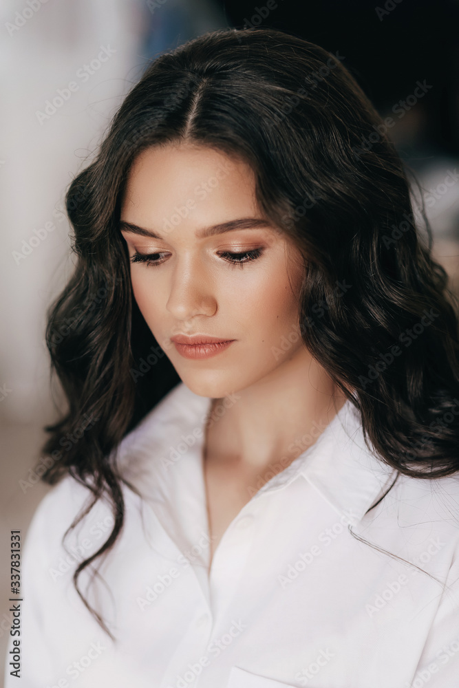 Portrait of beautiful young brunette girl with makeup