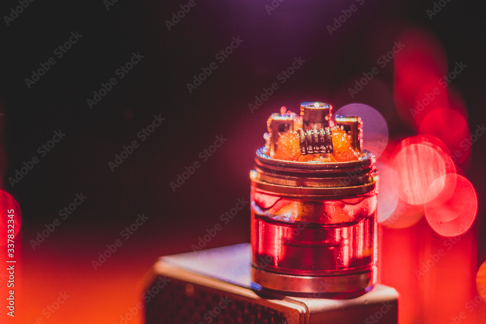 Vape concept. Electronic Cigarette vape explosion. Smoke clouds and vape liquid bottles on dark background. Vape concept. Electronic Cigarette vape explosion. Smoke clouds and vape liquid bottles on dark background.