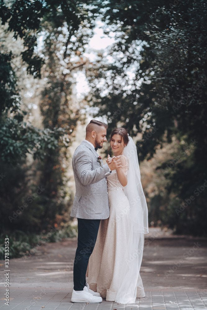 Bride and Groom at wedding Day walking Outdoors on spring nature. Bridal couple, Loving wedding couple outdoor. Bride and Groom at wedding Day walking Outdoors on spring nature. Bridal couple, Loving wedding couple outdoor.