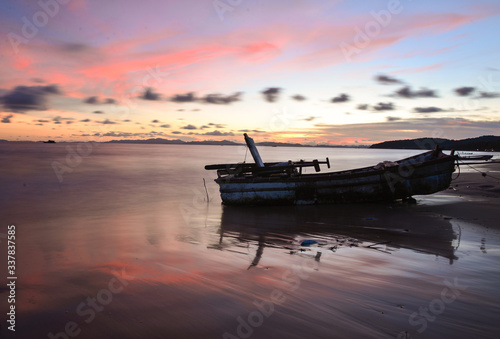 Sunset and abandoned boat