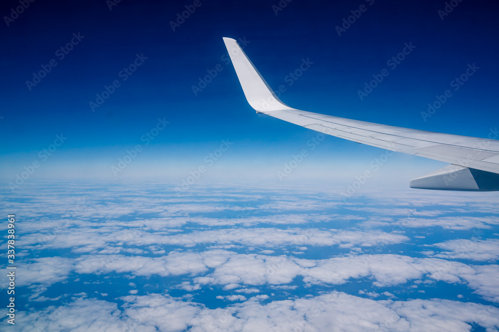 clouds under the wing of an airplane clouds under the wing of an airplane