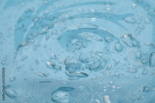 Sample of light blue cosmetic gel as background, closeup