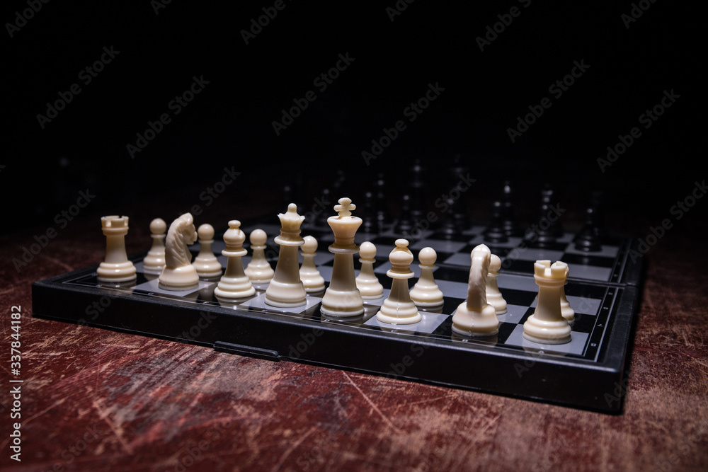 Chess figures on a dark background with smoke and fog. Selective focus Chess figures on a dark background with smoke and fog. Selective focus