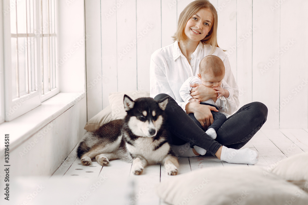 Beautiful woman with child. Woman in a white shirt. Family playing with big dog. Beautiful woman with child. Woman in a white shirt. Family playing with big dog.