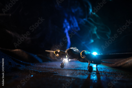 German Junker (Ju-88) night bomber at night. Artwork decoration with scale model of jet-propelled plane in possession. photo