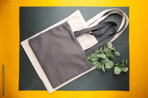 Zero waste conception, cotton bags for free plastic shopping on yellow background