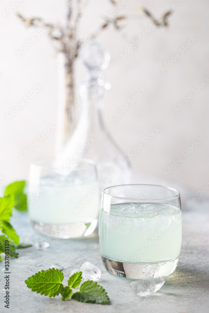 glass of cold drink with fresh mint leaves and ice cubes glass of cold drink with fresh mint leaves and ice cubes