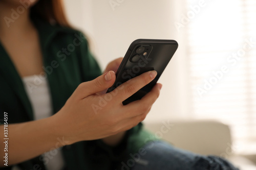 Photography MYKOLAIV, UKRAINE - MARCH 16, 2020: Woman holding iPhone 11 Black indoors, close