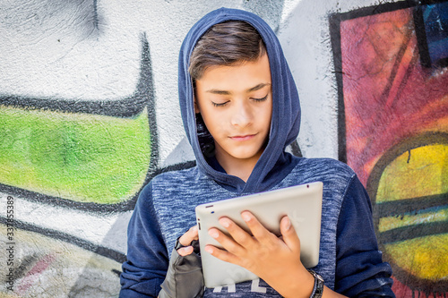 Happy smiling young man, boy holding looking at tablet pad computer present,  touch screen