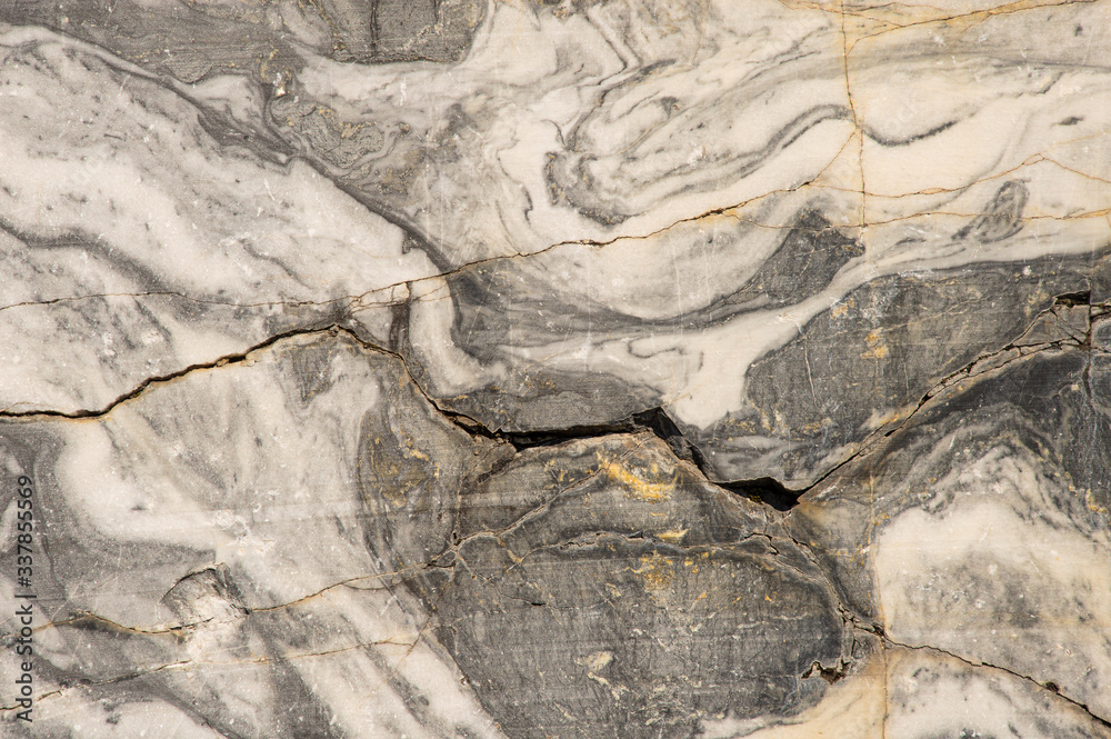 Ancient rocks, material surface, rock background, large marble texture,  stone in the cut, age-old traces. Stock Photo