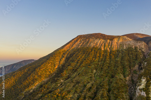 Aerial view photo from flying drone of Amazing grand Vulcano crater with fumaroles on Island at sunset. Of Vulcano, into Lipari ,Eolie Islands. Panoramic View of crater taken Italy, Sicily (series)