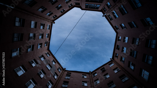 View of the blue sky from the depths of the courtyard