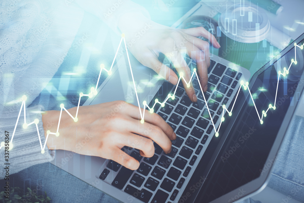 Double exposure of woman hands typing on computer and forex chart hologram drawing. Stock market invest concept. Double exposure of woman hands typing on computer and forex chart hologram drawing. Stock market invest concept.