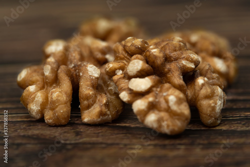 halves of walnuts on a wooden background