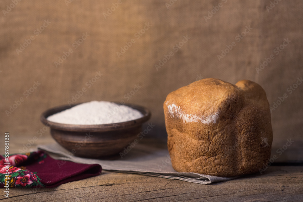 Village freshly baked bread on a table with eggs and flour Village freshly baked bread on a table with eggs and flour