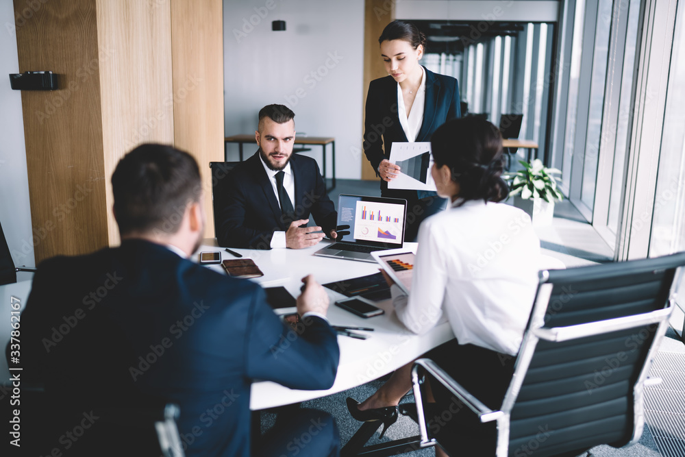 Focused colleagues presenting project in office