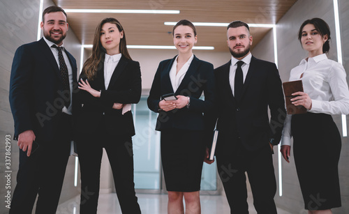 Successful coworkers standing in corridor