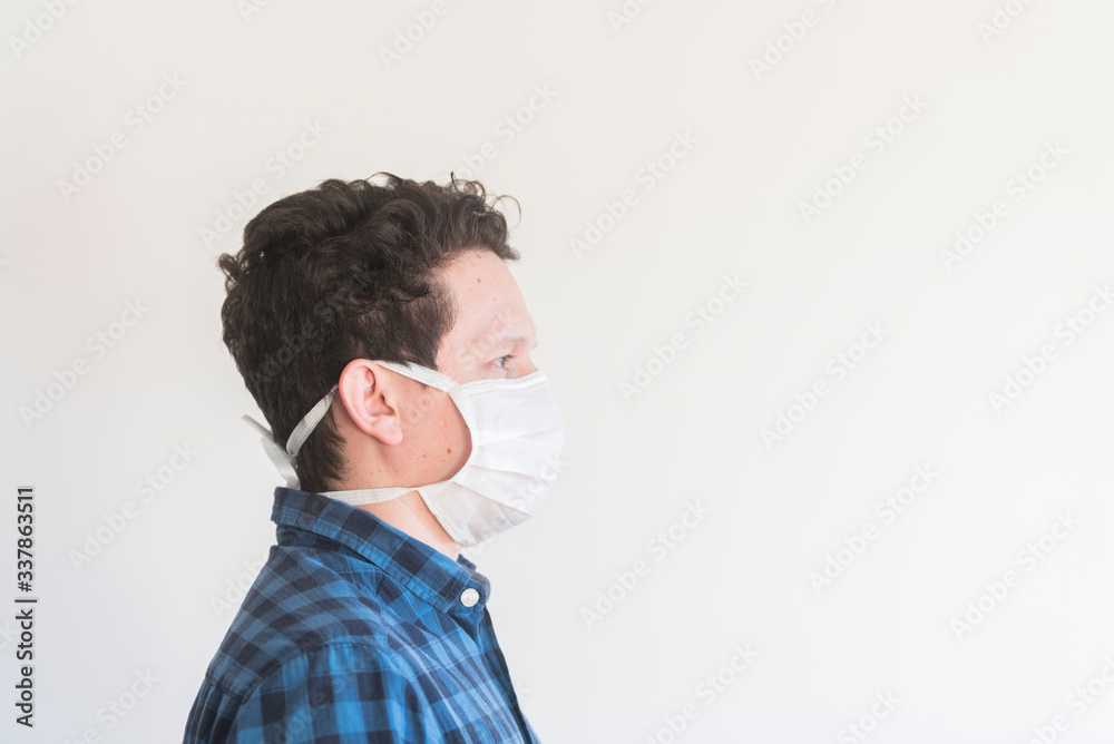 Man wearing a disposable face mask, to prevent the spread of the coronavirus Man wearing a disposable face mask, to prevent the spread of the coronavirus