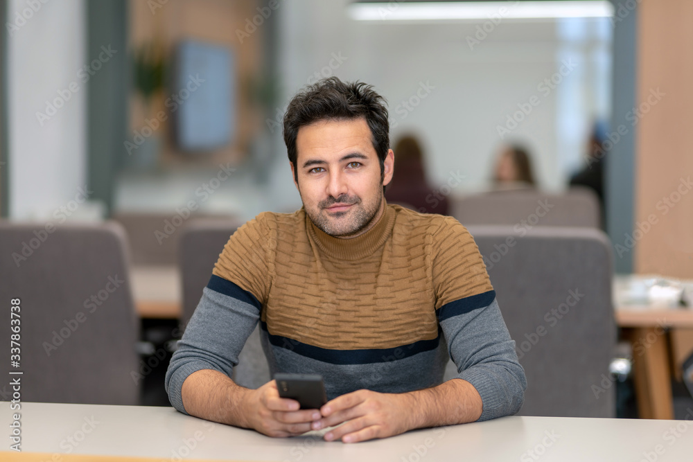 A handsome man texting with his lover on a smartphone A handsome man texting with his lover on a smartphone