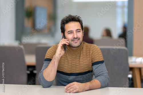 A handsome man who happily talks to his lover on a smartphone