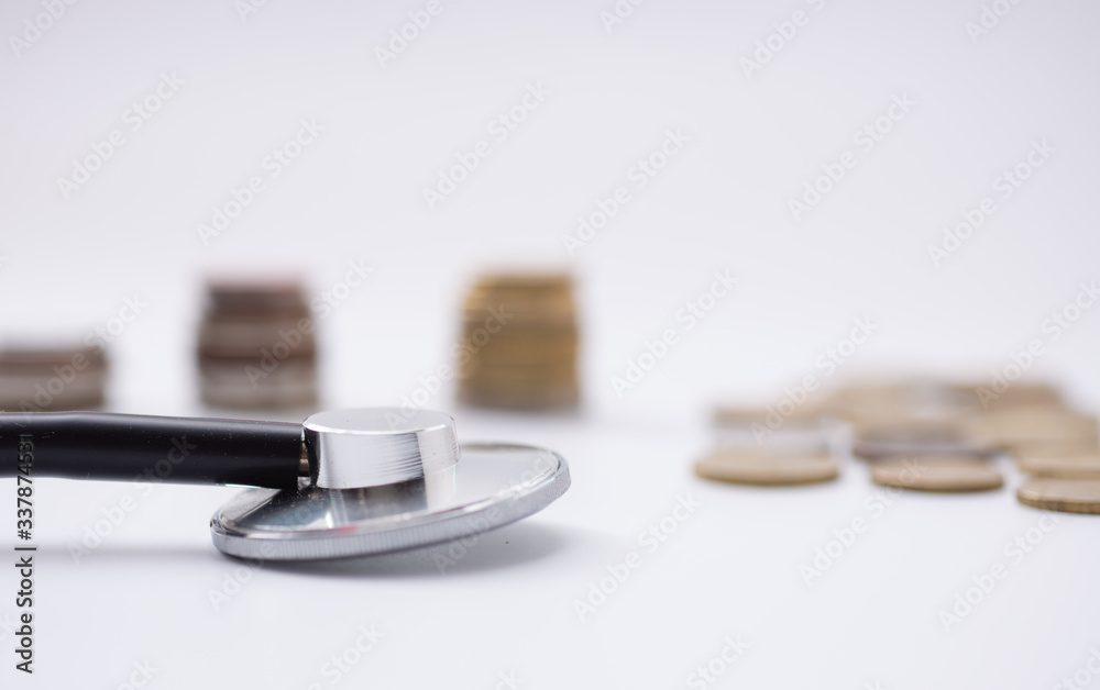 Stethoscope on coin stack, Dollar, and red heart on white background. money for health care, Financial Aid, concept