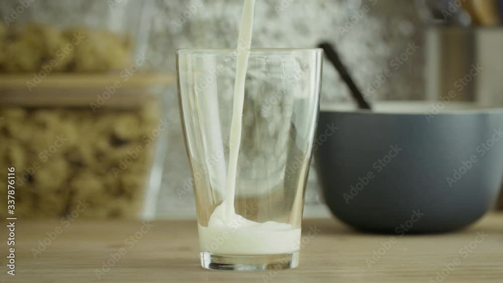 Milk pouring into a tall glass Milk pouring into a tall glass