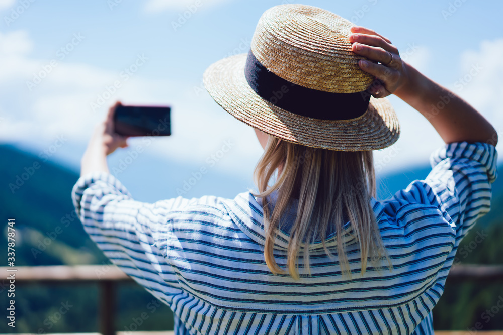 Fototapeta premium Anonymous traveler taking selfie in nature