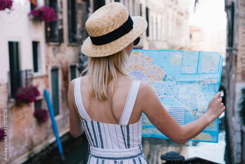 Young woman holding and looking at map