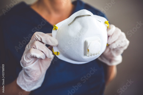 Doctor wearing protection face mask and latex gloves against coronavirus. Banner panorama medical staff preventive gear.