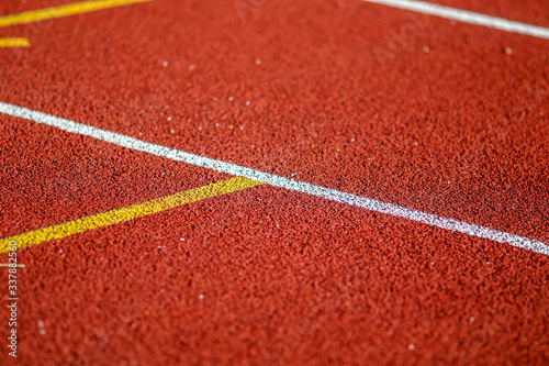Red running sport track background and texture. Sport running track concept. © Golden House Images