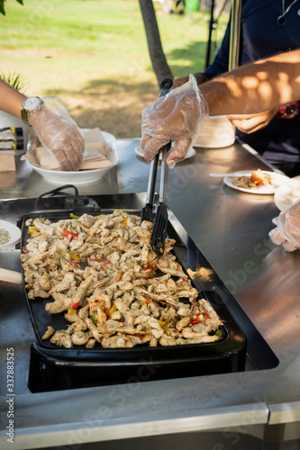 grilled chicken fajitas, prepared outdoors on a chrome table