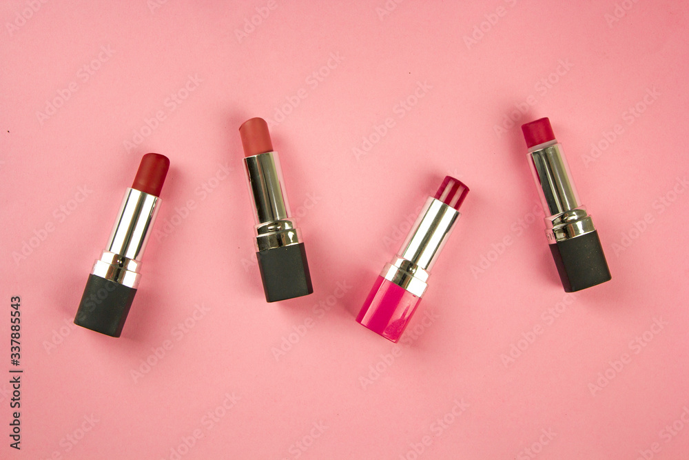 Obraz premium lipstick on a pink background, the concept of decorative cosmetics for the face, visage and facial care, a female product, top view, for the cosmetic department of the store