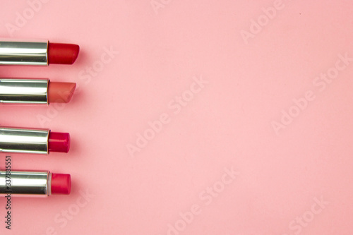 lipstick on a pink background, the concept of decorative cosmetics for the face, visage and facial care, a female product, top view, for the cosmetic department of the store