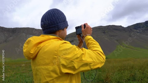 Wallpaper Mural Man taking pictures of mountains and landscapes, on a cloudy day, in Iceland Torontodigital.ca