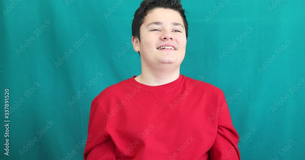 Portrait of a caucasian handsome young boy pointing and laughing gainst chroma key green screen background Portrait of a caucasian handsome young boy pointing and laughing gainst chroma key green screen background