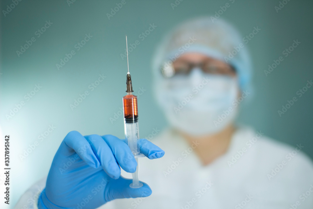 Nurse in the lab with a syringe, blood test for coronavirus. Nurse in the lab with a syringe, blood test for coronavirus.